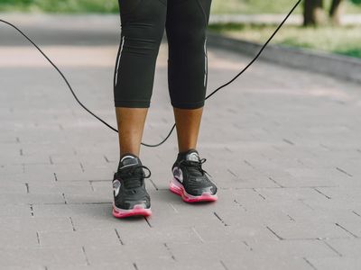 Feet of a person in sneakers during exercise.