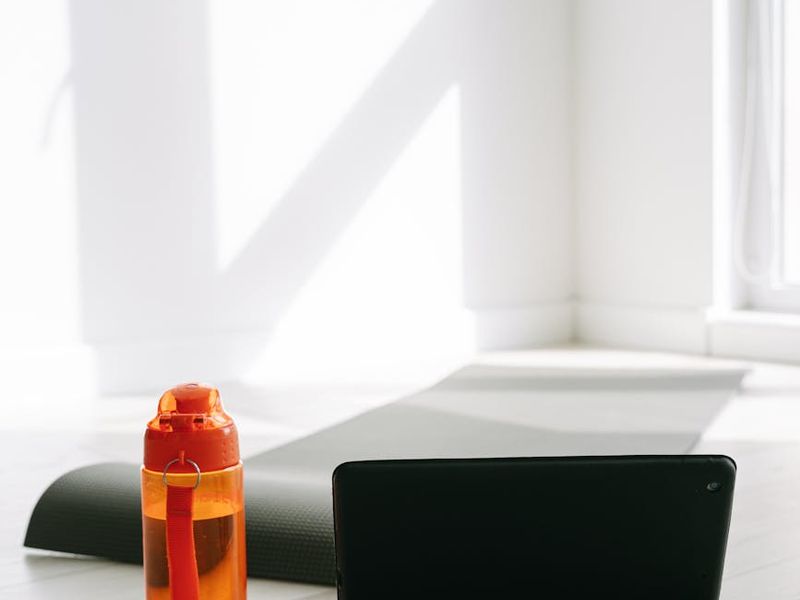 Minimalist interior showing a mat and water bottle.